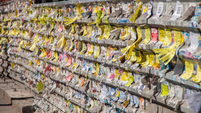 Close-up of torn adverts on wall